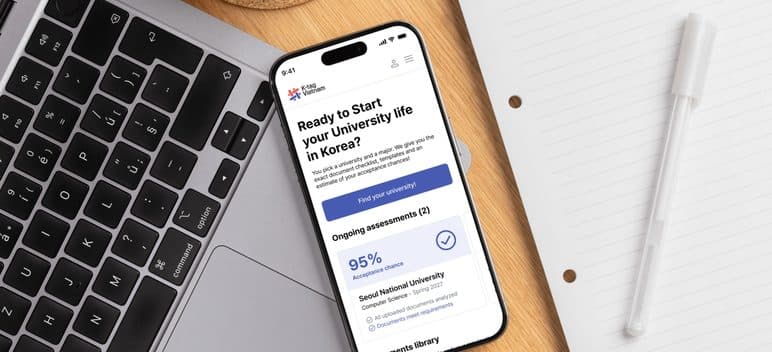 The moduuhak app open on a phone beside a keyboard
