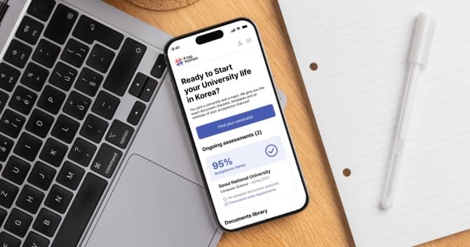 The moduuhak app open on a phone beside a keyboard